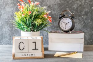 clock and flowers on table